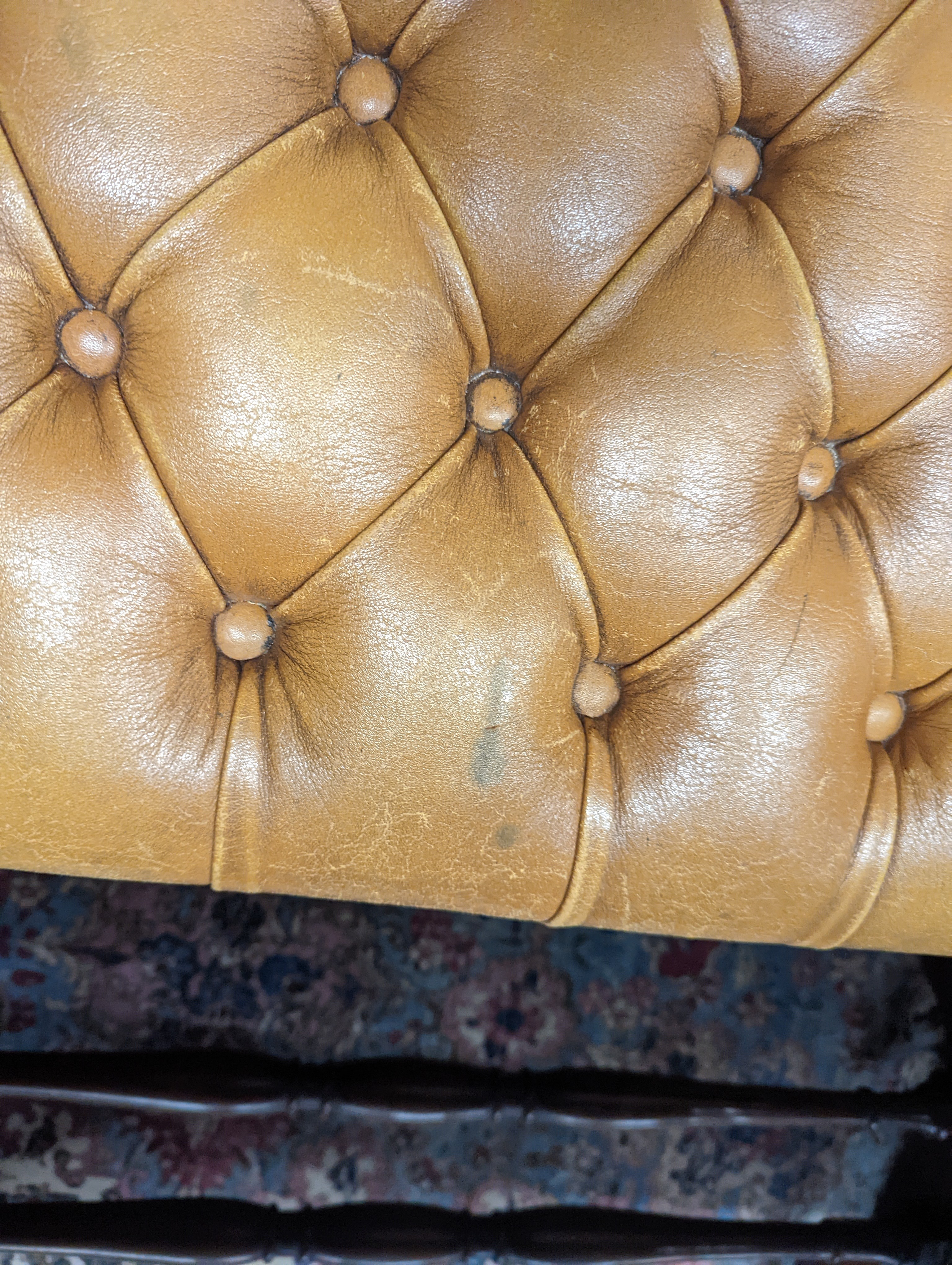 A Victorian carved X-framed rosewood footstool, upholstered in a buttoned brown leather, width 90cm depth 57cm height 42cm